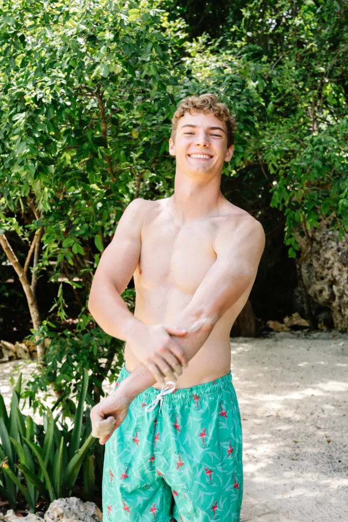A guest spreading mineral clay along his arm at the Nature Spa