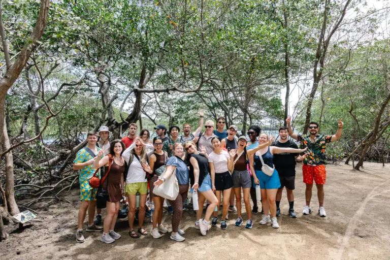 A tour group posing together under the mangrove canopy at Charankako Bay